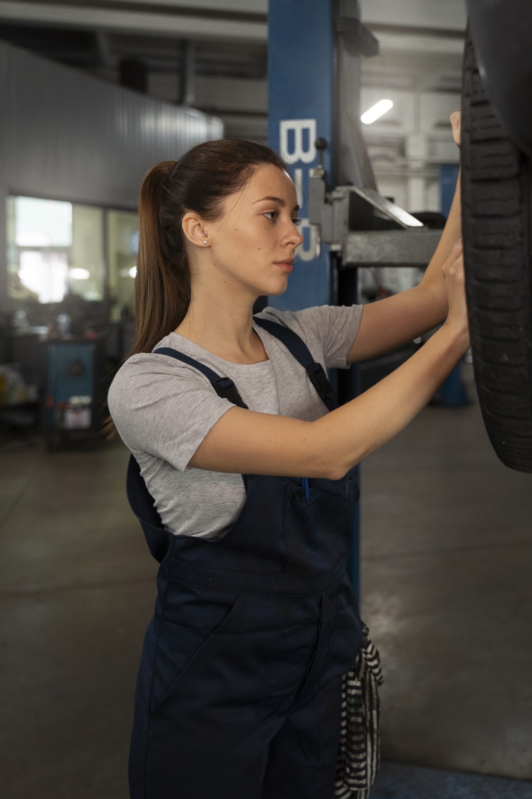 female-mechanic-working-shop-car